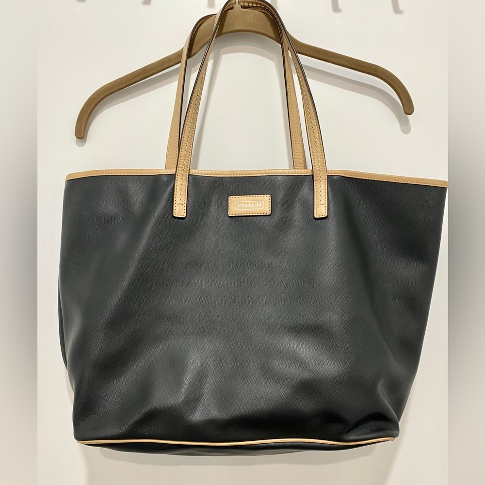 Black and tan Coach carry all bag